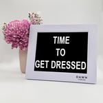 Original Dawn Clock shown on a table with the "Time to get dressed" reminder on the screen. This is ideal for all ages and proved essential for NDIS participants, people living with Dementia, people living with a disability and seniors. ADHD Autism Disability Dementia Alzheimer's