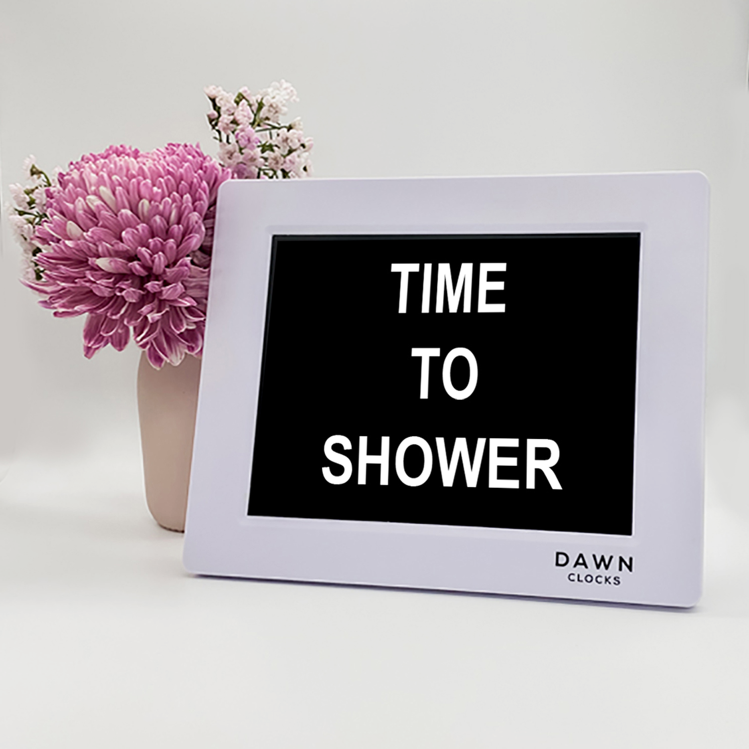 Original Dawn Clock shown on a table with the "Time to shower" reminder on the screen. This is ideal for all ages and proved essential for NDIS participants, people living with Dementia, people living with a disability and seniors.