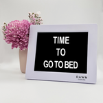 Original Dawn Clock shown on a table with the "Time to go to bed" reminder on the screen. This is ideal for all ages and proved essential for NDIS participants, people living with Dementia, people living with a disability and seniors.