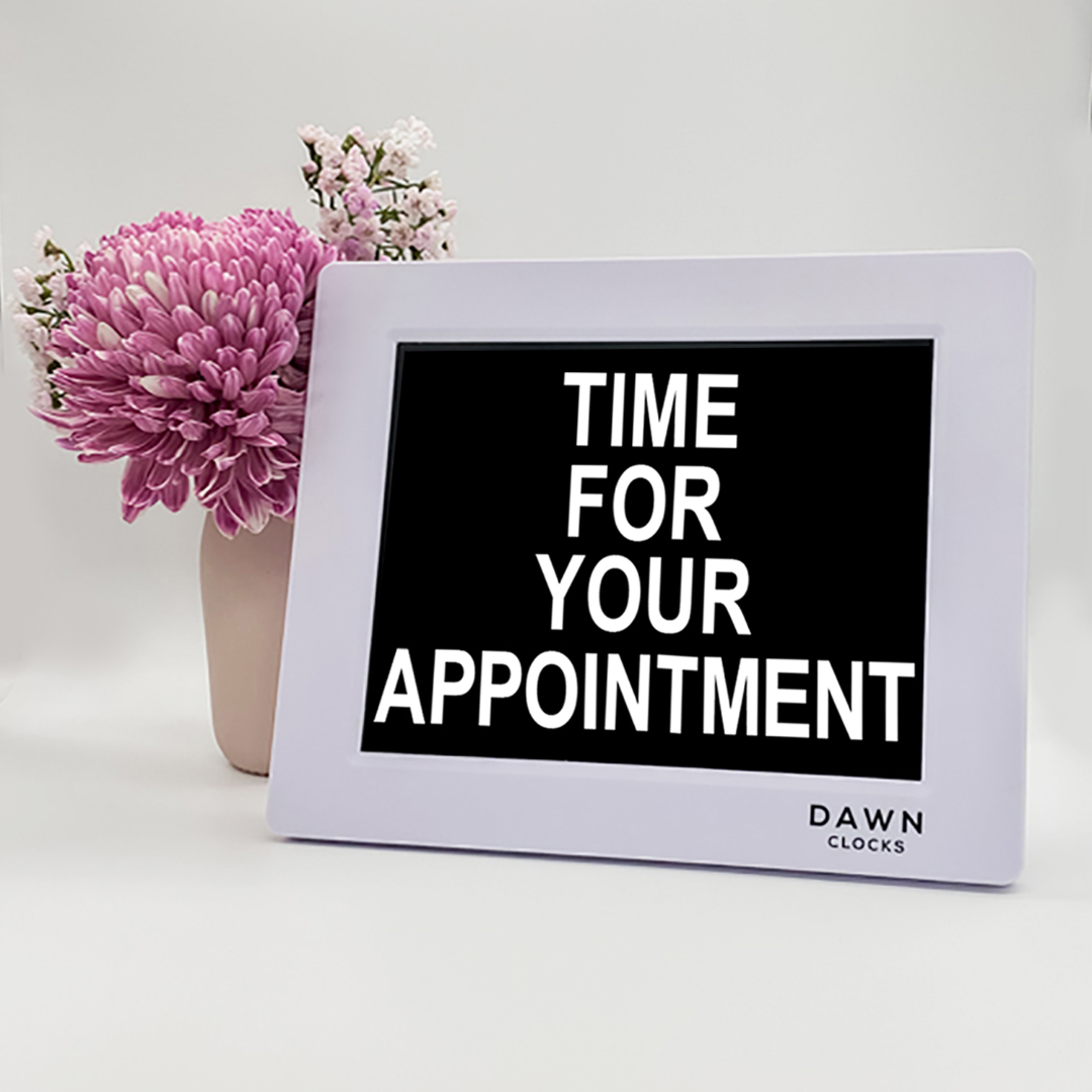 Original Dawn Clock shown on a table with the "Time for your appointment" reminder on the screen. This is ideal for all ages and proved essential for NDIS participants, people living with Dementia, people living with a disability and seniors. ADHD Autism Disability Dementia Alzheimer's
