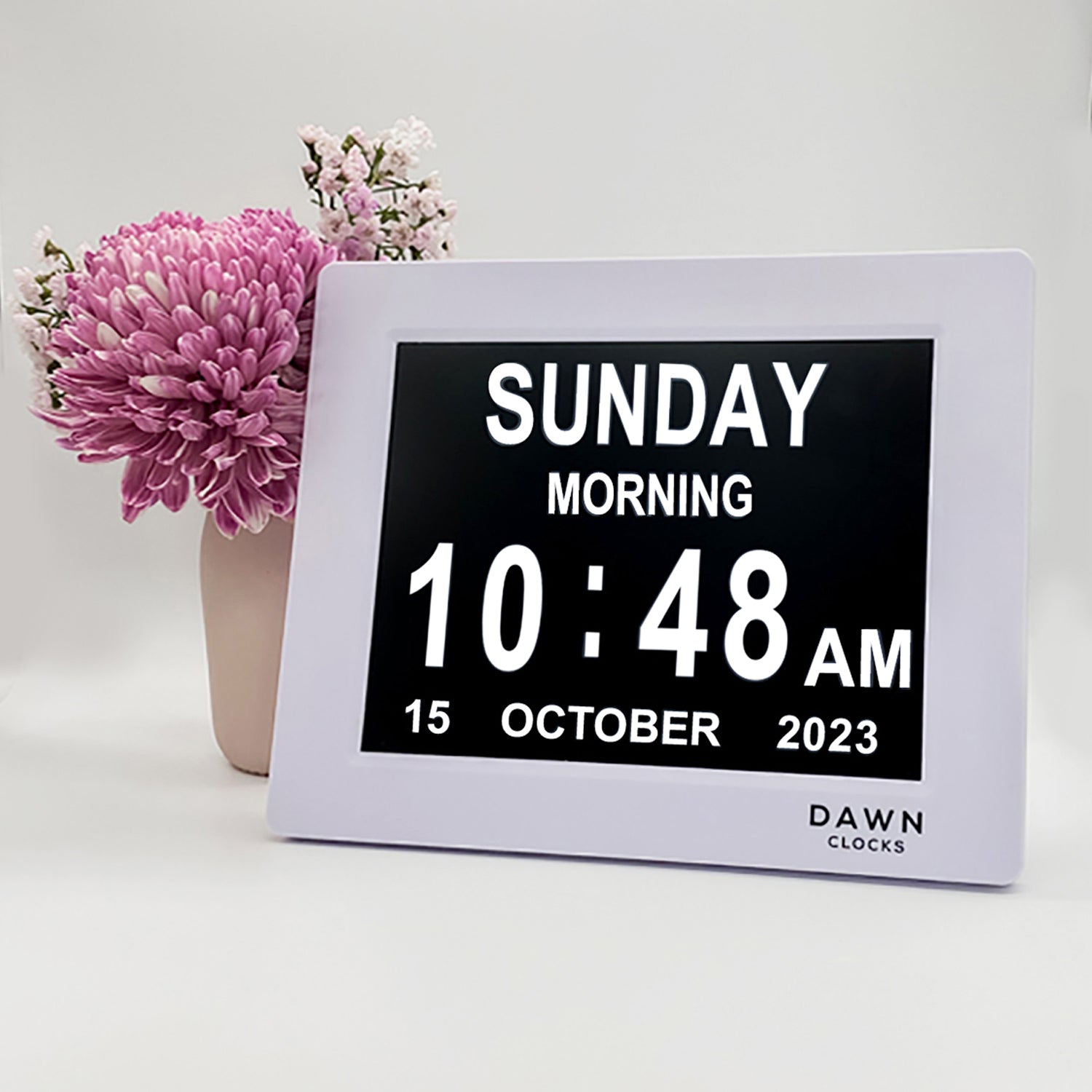 Original Dawn Clock - Calendar and Date Screen on table. The Dawn Clock™ is the original LED calendar day clock that has specially designed on-screen alerts to enable independence in completing daily tasks. The on screen reminder alerts help to alleviate the stress of reminding as well as the frustration of being reminded. With a high contrast and low glare screen, The Dawn Clock™ is easy to read and understand. Plug in and go with an automatic start and a user-friendly interface making setup a dream.