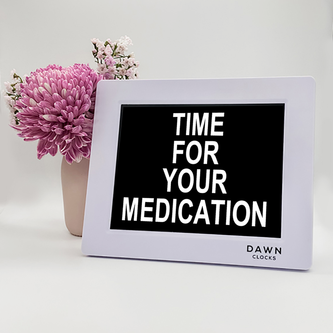 Original Dawn Clock shown on a table with the "Time for your medication" reminder on the screen. This is ideal for all ages and proved essential for NDIS participants, people living with Dementia, people living with a disability and seniors. ADHD Autism Disability Dementia Alzheimer's